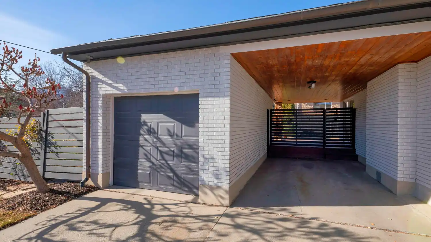 Garage Door Repair in Scottsdale performed on a residential home showing technician fixing broken garage spring