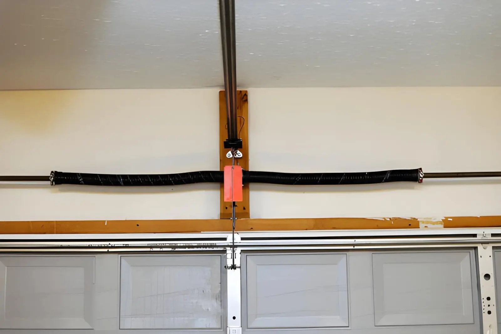 Close-up of damaged coil showing Garage Door Spring Repair needed for safe operation