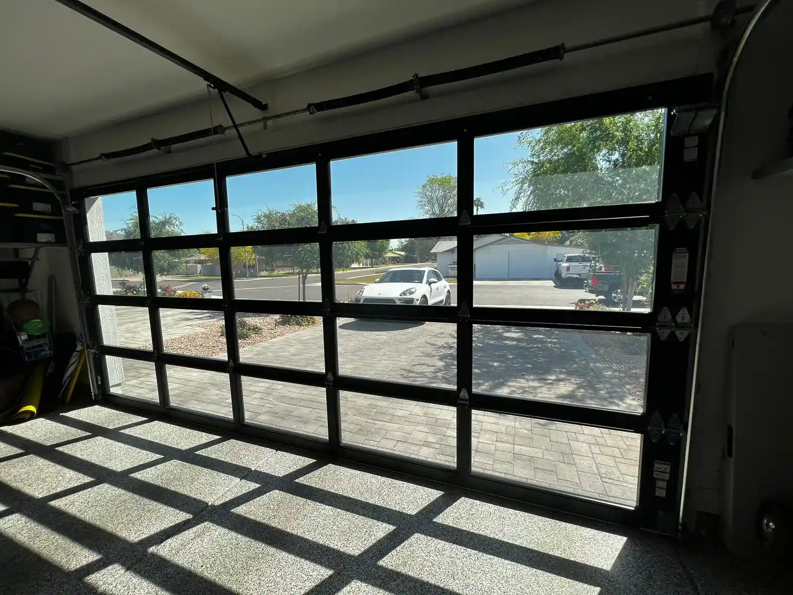 Garage Door Repair in Sun City showing expert repairing faulty garage door opener motor in suburban home